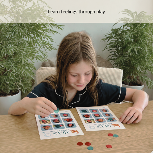 Child playing Mia Feelings Bingo game, learning to recognise emotions through matching and play